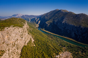 Wall Mural - Panoramic aerial view on Cetina river and mountains near town Omis. Croatia, august 2020