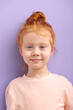 © alfa27 - cute smiling caucasian child girl with red hair and big blue eyes isolated over purple background. natural red haired girl with freckles look at camera with pleasant face, glad and nice girl