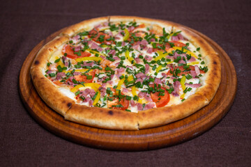 pizza with flask, tomatoes and green onions