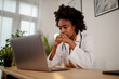 © Nebojsa - Displeased black healthcare worker using computer and reading an e-mail at doctor's office.