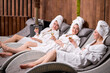 © alfa27 - Relaxed ladies enjoy drinking champagne at spa. Three beautiful caucasian women wearing bathrobes having cool resting, holidays in wellness center