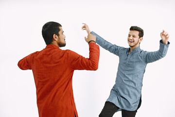 Two Indian men dancing on white background