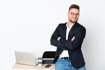 Sticker - Russian man in a office isolated on white background with arms crossed and happy