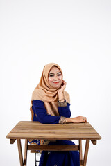 A pretty muslim female student with hijab posing isolated on white background