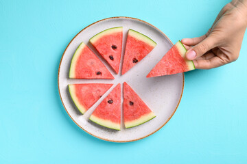 Sliced watermelon fruit picking by hand on plate with color background, Tropical fruit, Summer season