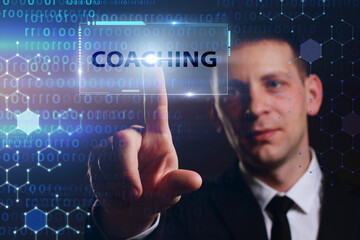 Business, Technology, Internet and network concept. Young businessman working on a virtual screen of the future and sees the inscription: Coaching