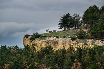 mountain cliff over green pine forest during cloudy day, Kislovodsk city, caucasus mountains, Russia