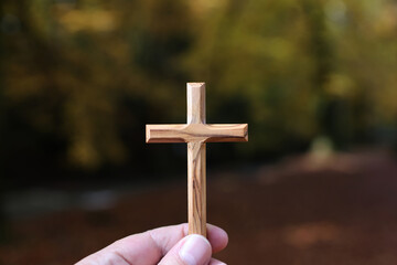 Wall Mural - Christian wooden cross in hand. Faith and spirituality.