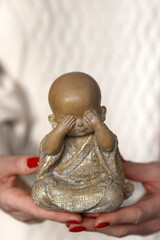 Buddhist monk  statue in hand.  France.