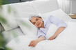 © Syda Productions - old age and people concept - senior woman sleeping in bed at home bedroom