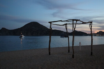 Beach with a view across the bay at sunset to the rocky cape near El Arco in Los Cabos, Mexico