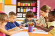 © Robert Kneschke - Group of children in preschool doing creative painting
