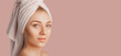 © Daria Lukoiko - Beautiful sensual young girl with clean skin on a pink background with a mockup. Topless woman in a towel. The concept of spa treatments, natural beauty and care, youth, cream and mask, freshness