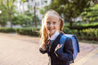 © Алина Бузунова - Back to school. Little girl from elementary school outdoor. Kid going learn new things 1th september