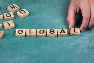 Canvas Print - GLOBAL. Wooden alphabet letters on a green blackboard background