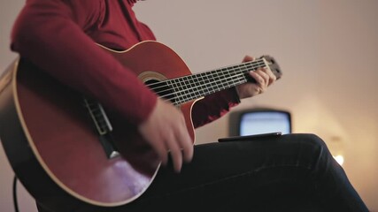 Wall Mural - Male musician playing acoustic guitar on the amplifier in retro vintage room.