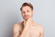 © deagreez - Portrait of attractive cool groomed guy touching chin sensual everyday care isolated over grey pastel color background