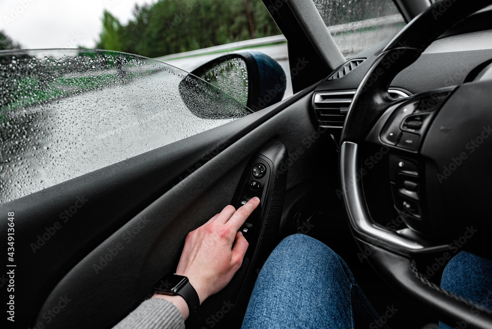 Hand press on car automatic window control. Stock Photo | Adobe Stock
