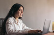 © PEDROMERINO - attractive young woman using her laptop in a desk