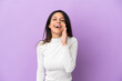 © luismolinero - Young caucasian woman isolated on purple background shouting with mouth wide open