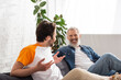 © LIGHTFIELD STUDIOS - Mature man smiling at blurred son at home