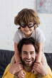 © LIGHTFIELD STUDIOS - Smiling kid in aviator goggles hugging father