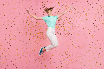 Poster - Full size photo of attractive cheerful person raise arms jumping have fun star confetti isolated on pink color background