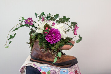 Wall Mural - Flower growing out of a boot on display at a flower show