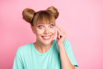 Wall Mural - Photo of cheerful charming girl finger on temple beaming smile look camera isolated on pink color background