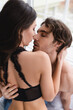 © LIGHTFIELD STUDIOS - Passionate woman in bra kissing boyfriend