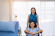 © wirojsid - Senior woman patient sitting on wheelchair with relative daughter in wardroom at hospital, treatment and recovering, healthcare concept.