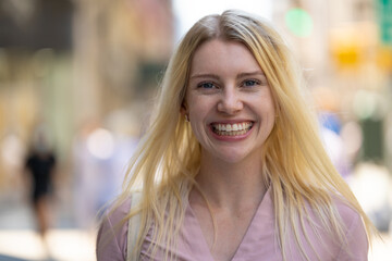 Poster - Young caucasian woman in city smile happy face portrait