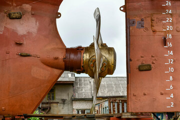 Wall Mural - Variable pitch propeller and rudder. Cargo vessel ashore on ship repairing yard.