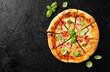 © Nelea Reazanteva - Fresh Homemade Italian Pizza Margherita with mozzarella cheese,cherry tomatoes and fresh  basil leaves. Black stone background, top view
