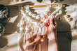 Close up of women's hands weaving macrame from white cotton threads in a home workshop.Home decor.Handmade concept.Selective focus with shallow depth of field,top view.