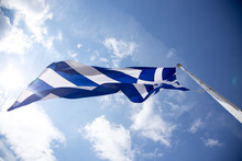 Greek Flag Against Blue Sky
