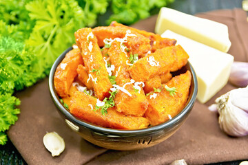 Poster - Pumpkin fried with spices in bowl on wooden board