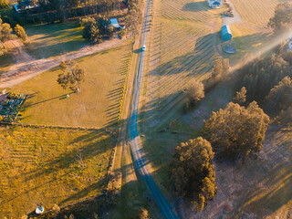Wall Mural - a small road between field in the rural area.