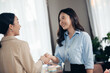 © nikomsolftwaer - asian businesswoman shake hands as hello in office closeup. Negotiating business. Image of businesswomen Handshaking. Connection Deal Concept