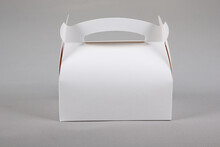 White small blank paper pastry candy box with handle in grey background
