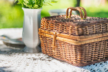 Wicker Basket And White Delicate Flowers In The Garden, Fresh Flowers Near The Wicker Basket In Summer. Beautiful Juicy Bright Romantic Still Life In The Garden In Spring