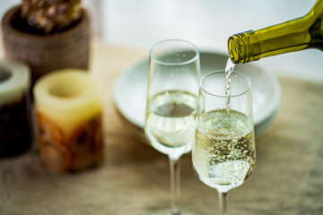 Two glasses of sparkling wine on dining table.Modern lifestyle image.
