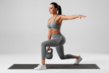 Athletic Girl Doing Lunges Exercises With Kettlebell, Leg Muscle Training. Fitness Woman Doing Front Forward One Leg Step Lunge