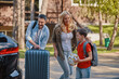 © gstockstudio - Happy family with little boy packing stuff into the car and smiling while standing in front of the house