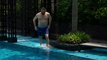 Young Man Doing Cannonball Jump Into Swimming Pool, Super Slow Motion