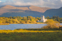 Golden Hour Sunset Light On Scenic Mountain Landscape Of The Historic Medieval Ross Castle On Lough Leane Lake In Killarney National Park, County Kerry, Ireland.