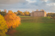 Vibrant golden hour sunset light over the historic Dalkeith Palace manor in Dalkeith Country Park, Edinburgh, Scotland.