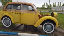 Volgograd, Russia - 09.05.2021: Old Yellow Car Without Engine, Monument
