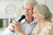 © aletia2011 - Senior couple singing karaoke