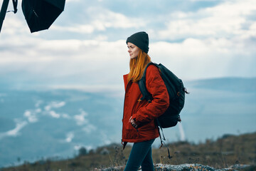 Wall Mural - portrait of a traveler in the mountains in nature rock landscape clouds sky model